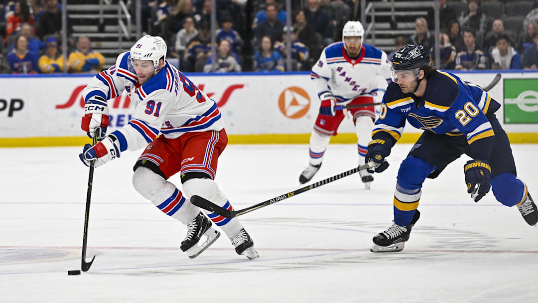 Apr 6, 2023; St. Louis, Missouri, USA;  New York Rangers right wing Vladimir Tarasenko (91) controls the puck as St. Louis Blues left wing Brandon Saad (20) defends during the first period at Enterprise Center. Mandatory Credit: Jeff Curry-Imagn Images