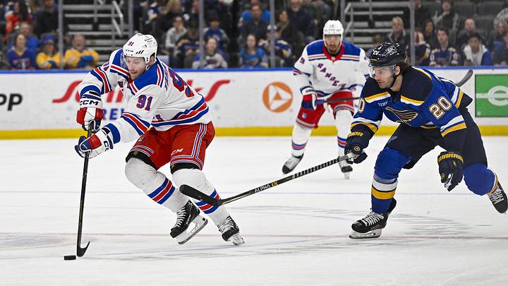 Apr 6, 2023; St. Louis, Missouri, USA;  New York Rangers right wing Vladimir Tarasenko (91) controls the puck as St. Louis Blues left wing Brandon Saad (20) defends during the first period at Enterprise Center. Mandatory Credit: Jeff Curry-Imagn Images
