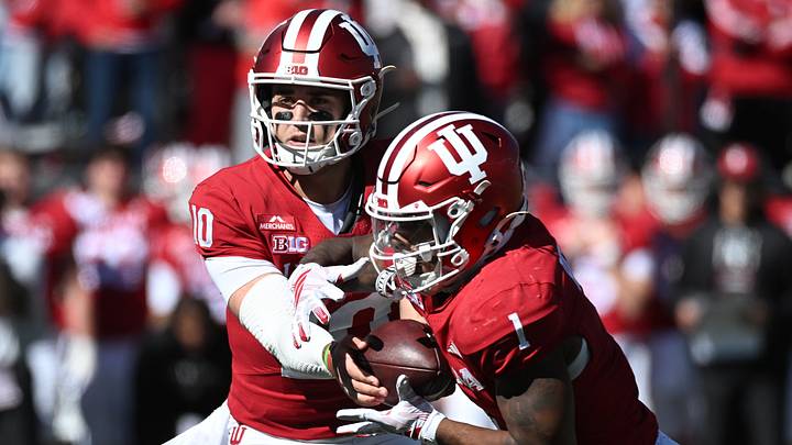 Oct 17, 2026; Bloomington, Indiana, USA;  Indiana Hoosiers quarterback Josh Hoover (10) hands off to\ running back Turbo Richard (1) during the first half against the Ohio State Buckeyes at Merchants Bank Field at Memorial Stadium.  Mandatory Credit: Robert Goddin-Imagn Images