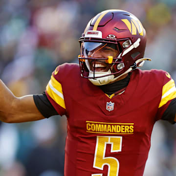 Dec 22, 2024; Landover, Maryland, USA; Washington Commanders quarterback Jayden Daniels (5) celebrates after throwing a touchdown during the fourth quarter against the Philadelphia Eagles at Northwest Stadium. Mandatory Credit: Peter Casey-Imagn Images