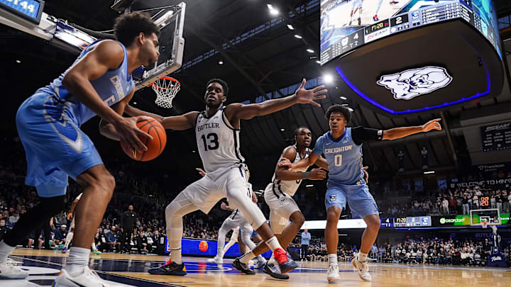 Creighton Bluejays guard Nik Graves (5) searches to pass the ball against Butler Bulldogs center Drayton Jones (13) on Wednesday, March 4, 2026, during the game at Hinkle Fieldhouse in Indianapolis.