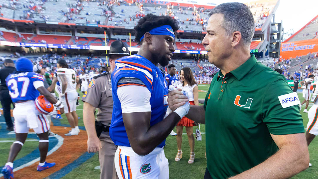 Miami Hurricanes head coach Mario Cristobal shakes hands with Florida Gators defensive back Trikweze Bridges (7) after the Hurricanes defeated the Gators during the season opener.