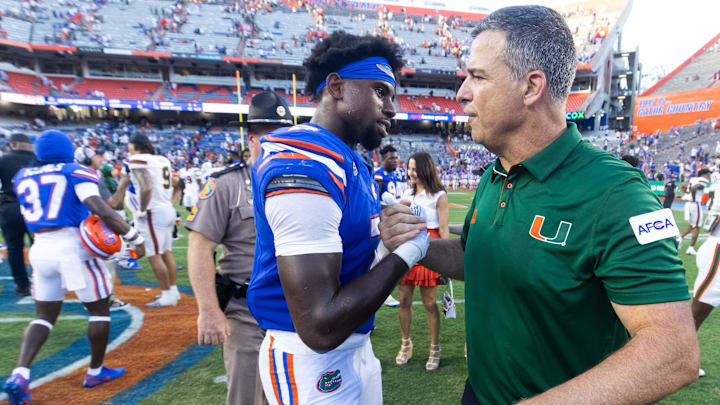 Miami Hurricanes head coach Mario Cristobal shakes hands with Florida Gators defensive back Trikweze Bridges (7) after Hurricanes defeated the Gators during the season opener at Ben Hill Griffin Stadium in Gainesville, FL on Saturday, August 31, 2024 against the University of Miami Hurricanes. The Hurricanes defeated the Gators 41-17. [Doug Engle/Gainesville Sun]