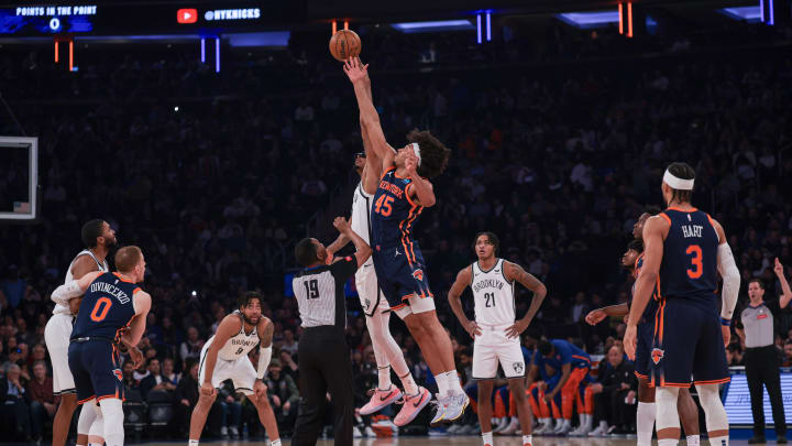 Apr 12, 2024; New York, New York, USA; Brooklyn Nets center Nic Claxton (33) tips off against New York Knicks center Jericho Sims (45) to start the game at Madison Square Garden. Mandatory Credit: Vincent Carchietta-USA TODAY Sports