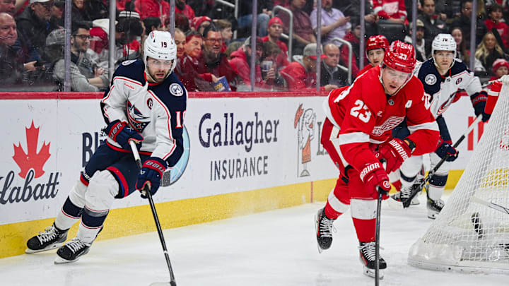 Detroit Red Wings left wing Raymond and Columbus Blue Jackets center Fantilli battle for the puck during the second period at Little Caesars Arena. 