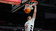 Cincinnati Bearcats guard Shon Abaev (10) dunks in the first half of the NCAA Men’s Basketball game between the Cincinnati Bearcats and the Dayton Flyers at Fifth Third Arena in Cincinnati on Tuesday, Nov. 11, 2025.