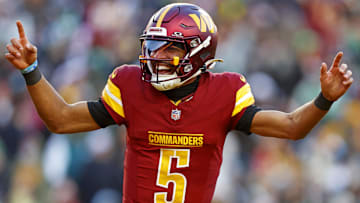 Dec 22, 2024; Landover, Maryland, USA; Washington Commanders quarterback Jayden Daniels (5) celebrates after throwing a touchdown during the fourth quarter against the Philadelphia Eagles at Northwest Stadium. Mandatory Credit: Peter Casey-Imagn Images