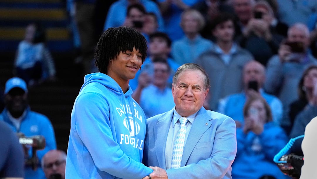Dec 14, 2024; Chapel Hill, North Carolina, USA; North Carolina Tar Heels head football coach Bill Belichick with recruit quarterback Bryce Baker during half time at Dean E. Smith Center. Mandatory Credit: Bob Donnan-Imagn Images