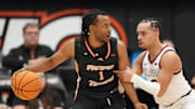 Feb 8, 2025; Stockton, California, USA; Pacific Tigers guard Lamar Washington (1) dribbles against Gonzaga Bulldogs guard Ryan Nembhard (right) during the second half at Alex G. Spanos Center. Mandatory Credit: Darren Yamashita-Imagn Images