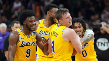 Oct 17, 2024; Phoenix, Arizona, USA; Los Angeles Lakers guard Bronny James (9) and Los Angeles Lakers guard Dalton Knecht (4) and Los Angeles Lakers guard Jalen Hood-Schifino (0) celebrate after defeating the Phoenix Suns at Footprint Center. Mandatory Credit: Joe Camporeale-Imagn Images