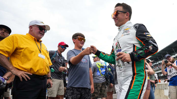 NASCAR Cup Series driver AJ Allmendinger (16) fists bumps Matthew Murphy from Columbus, Ind., ahead of the Brickyard 400, Sunday, July 21, 2024, at Indianapolis Motor Speedway.