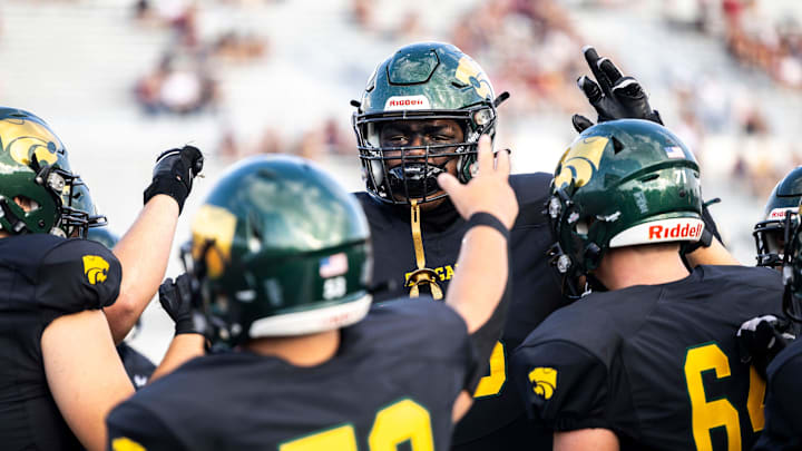 Cedar Rapids Kennedy's Nick Brooks huddles up with teammates during a Class 5A high school football game against Dowling Catholic, Saturday, Aug. 26, 2023, at Kingston Stadium in Cedar Rapids, Iowa.