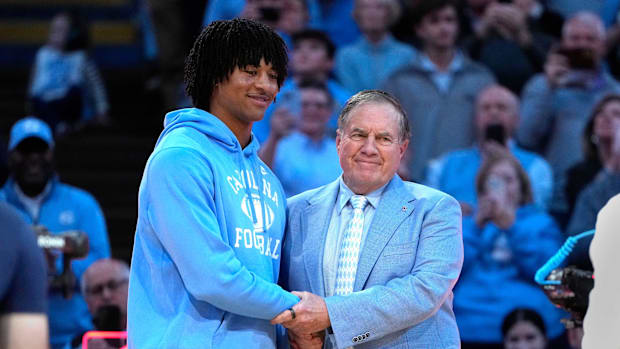  North Carolina Tar Heels head football coach Bill Belichick with recruit quarterback Bryce Baker during half time