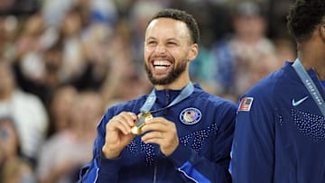 Aug 10, 2024; Paris, France; United States shooting guard Stephen Curry (4) celebrates with the gold medal after the game against France in the men's basketball gold medal game during the Paris 2024 Olympic Summer Games at Accor Arena. Mandatory Credit: Kyle Terada-USA TODAY Sports