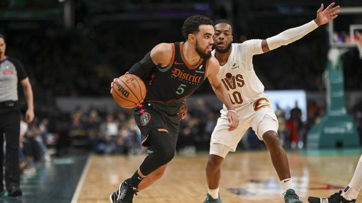 Feb 25, 2024; Washington, District of Columbia, USA; Washington Wizards guard Tyus Jones (5) dribbles as Cleveland Cavaliers guard Darius Garland (10) defends  during the second  half at Capital One Arena. Mandatory Credit: Tommy Gilligan-USA TODAY Sports