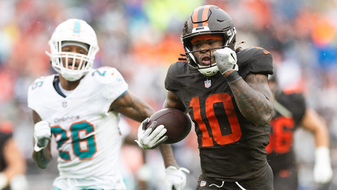 Oct 19, 2025; Cleveland, Ohio, USA; Cleveland Browns running back Quinshon Judkins (10) runs the ball for a touchdown against Miami Dolphins cornerback Rasul Douglas (26) during the second quarter at Huntington Bank Field. Mandatory Credit: Scott Galvin-Imagn Images