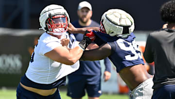 Jul 23, 2025; Foxborough, MA, USA; New England Patriots offensive tackle Will Campbell (66) and defensive end Keion White (99) work on a drill during training camp at Gillette Stadium. Mandatory Credit: Eric Canha-Imagn Images