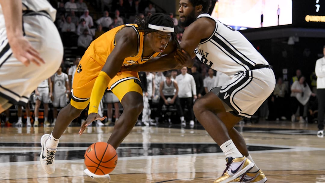 Mar 1, 2025; Nashville, Tennessee, USA;  Missouri Tigers guard Mark Mitchell (25) dribbles past Vanderbilt Commodores forward Jaylen Carey (22) during the second half at Memorial Gymnasium. Mandatory Credit: Steve Roberts-Imagn Images