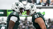 Oct 11, 2025; East Lansing, Michigan, USA; Michigan State quarterback Aidan Chiles (2) celebrates a touchdown with Michigan State tight end Michael Masunas (81) in the first quarter at Spartan Stadium. Mandatory Credit: Brendan Mullin-Imagn Images