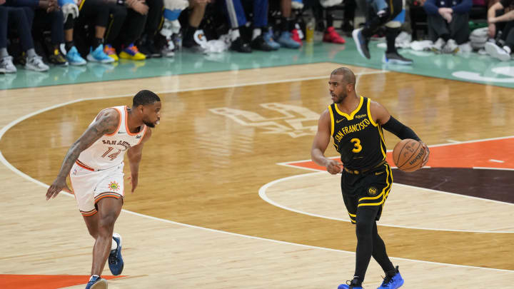 Mar 31, 2024; San Antonio, Texas, USA;  Golden State Warriors guard Chris Paul (3) dribbles in front of San Antonio Spurs guard Blake Wesley (14) in the first half at Frost Bank Center. Mandatory Credit: Daniel Dunn-USA TODAY Sports