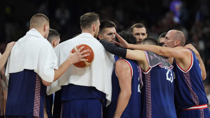 Jul 31, 2024; Villeneuve-d'Ascq, France; Serbia players celebrate after defeating Puerto Rico during the Paris 2024 Olympic Summer Games at Stade Pierre-Mauroy. Mandatory Credit: John David Mercer-USA TODAY Sports