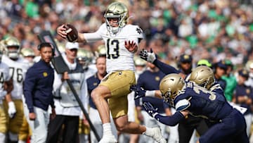 Oct 26, 2024; East Rutherford, New Jersey, USA;Notre Dame Fighting Irish quarterback Riley Leonard (13) carries the ball during the first half against the Navy Midshipmen at MetLife Stadium. Mandatory Credit: Vincent Carchietta-Imagn Images