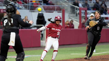 Oklahoma's Ailana Agbayani (50) gets caught in a rundown in between UCF's Beth Damon (80) and Sierra Humphreys (8) in the second inning of the college softball game between the University of Oklahoma Sooners and the UCF Knights at Love's Field in Norman, Okla., Friday, April, 4, 2025.