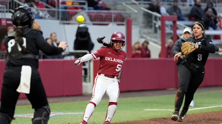 Oklahoma's Ailana Agbayani (50) gets caught in a rundown in between UCF's Beth Damon (80) and Sierra Humphreys (8) in the second inning of the college softball game between the University of Oklahoma Sooners and the UCF Knights at Love's Field in Norman, Okla., Friday, April, 4, 2025.