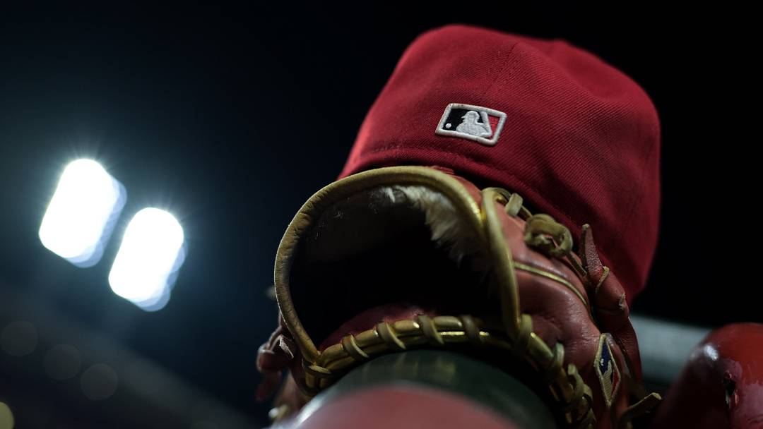 Aug 31, 2026; Cincinnati, Ohio, USA; The MLB logo on the field hat of a Cincinnati Reds player is seen resting on the dugout railing during the game against the San Diego Padres at Great American Ball Park. Mandatory Credit: Aaron Doster-Imagn Images Aug 31, 2026; Cincinnati, Ohio, USA; The MLB logo on the field hat of a Cincinnati Reds player is seen resting on the dugout railing during the game against the San Diego Padres at Great American Ball Park. Mandatory Credit: Aaron Doster-Imagn Images
