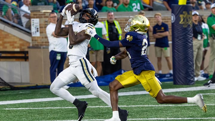 Sep 20, 2025; South Bend, Indiana, USA; Purdue Boilermakers wide receiver Nitro Tuggle (0) makes a catch for a touchdown as Notre Dame Fighting Irish cornerback Mark Zackery IV (24) defends in the first half at Notre Dame Stadium. Mandatory Credit: Michael Caterina-Imagn Images