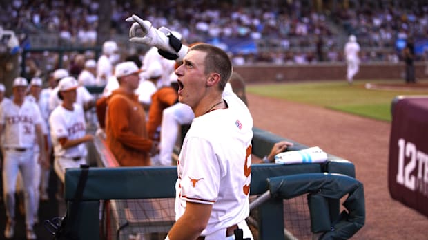 Texas Longhorns infielder Jared Thomas celebrates hitting a home run while wearing a white Texas uniform. 