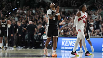 Oct 27, 2025; San Antonio, Texas, USA;  San Antonio Spurs guard Stephon Castle (5) celebrates in front of Toronto Raptors forward Collin Murray-Boyles (12) in the second half at Frost Bank Center. Mandatory Credit: Daniel Dunn-Imagn Images