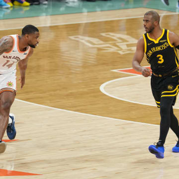 Mar 31, 2024; San Antonio, Texas, USA; Golden State Warriors guard Chris Paul (3) dribbles in front of San Antonio Spurs guard Blake Wesley (14) in the first half at Frost Bank Center. 