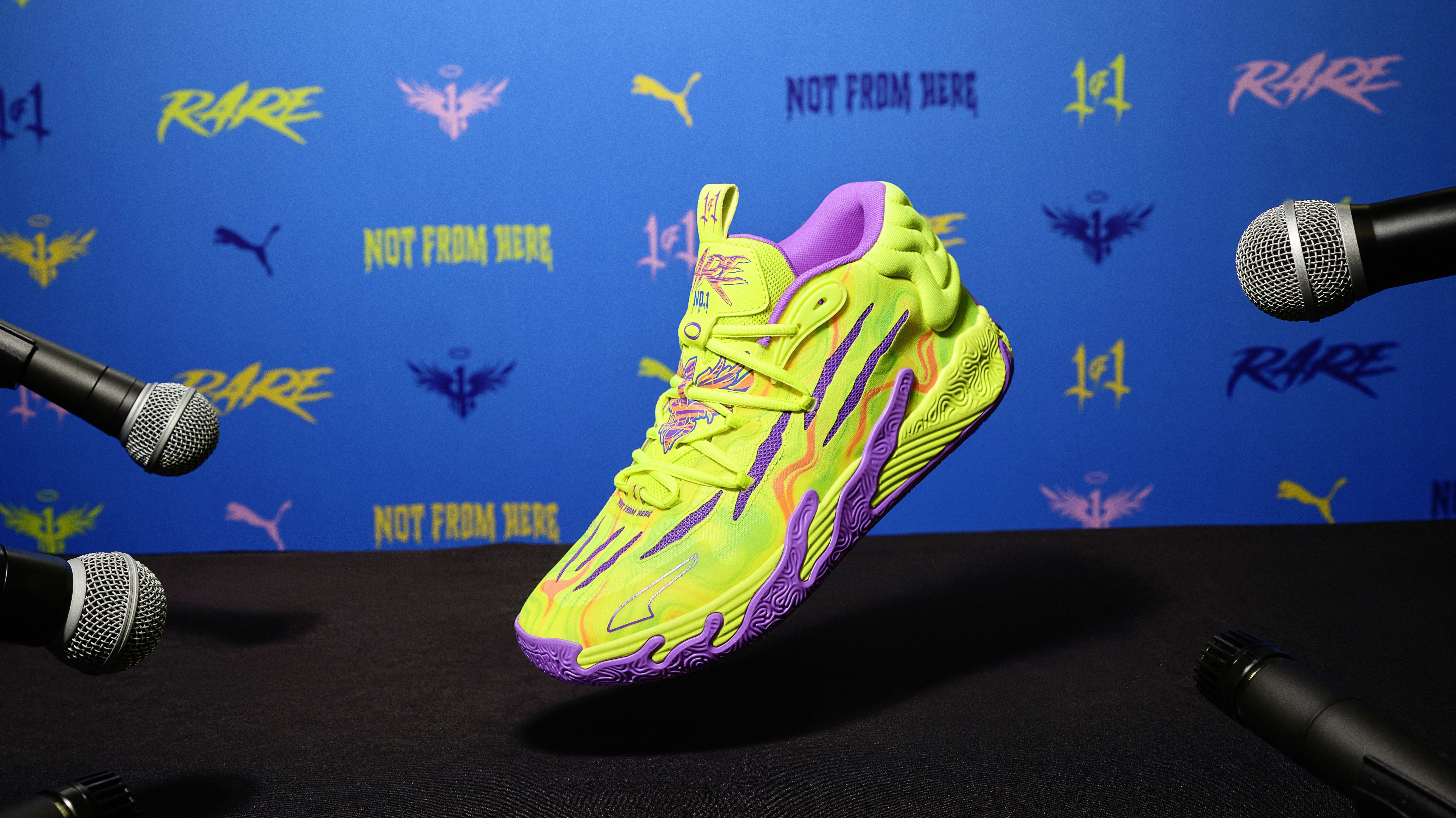 LaMelo Ball's yellow and purple PUMA sneakers sit on a podium.