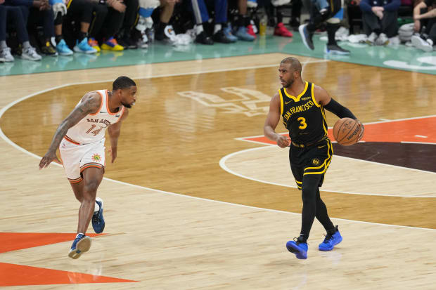 Golden State Warriors guard Chris Paul (3) dribbles in front of San Antonio Spurs guard Blake Wesley (14). 