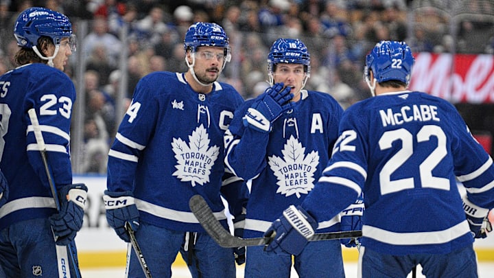 Oct 16, 2024; Toronto, Ontario, CAN; Toronto Maple Leafs forward Mitchell Marner (16) speaks with forwards Matthew Knies (23), Auston Matthews (34), and defenseman Jake McCabe before a faceoff against the Los Angeles Kings in the first period at Scotiabank Arena. Mandatory Credit: Dan Hamilton-Imagn Images