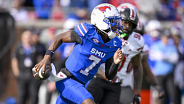 SMU Mustangs quarterback Kevin Jennings (7) runs with the ball during the first half against the Louisville Cardinals at Gerald J. Ford Stadium. 