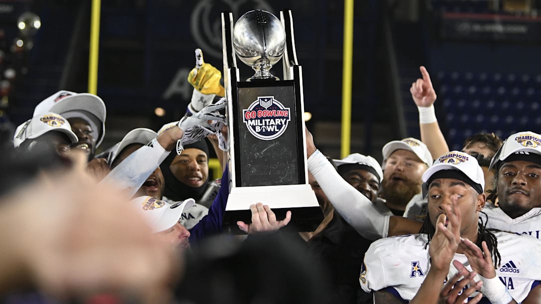 Dec 28, 2024; Annapolis, MD, USA; East Carolina Pirates hoists the Go Bowling Military Bowl  trophy after defeating North Carolina State Wolfpack at Navy-Marine Corps Memorial Stadium. Mandatory Credit: Tommy Gilligan-Imagn Images