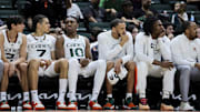 Jan 10, 2024; Coral Gables, Florida, USA; Miami Hurricanes guard Carson Mastin (2), guard Kyshawn George (7), and guard Paul Djobet (10) look on from the bench against the Louisville Cardinals during the second half at Watsco Center. Mandatory Credit: Sam Navarro-Imagn Images