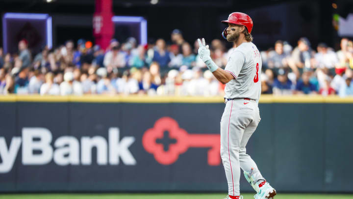 Aug 3, 2024; Seattle, Washington, USA; Philadelphia Phillies first baseman Bryce Harper (3) reacts towards the dugout after hitting a double against the Seattle Mariners during the fourth inning at T-Mobile Park. 