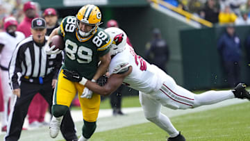 Green Bay Packers tight end Ben Sims (89) is tackled by Arizona Cardinals outside linebacker Zaven Collins (25) after catching a pass during the third quarter at Lambeau Field.
