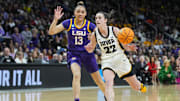 Apr 1, 2024; Albany, NY, USA; Iowa Hawkeyes guard Caitlin Clark (22) controls the ball against LSU Lady Tigers guard Last-Tear Poa (13) in the fourth quarter in the finals of the Albany Regional in the 2024 NCAA Tournament at MVP Arena. Mandatory Credit: Gregory Fisher-Imagn Images