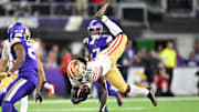 Oct 23, 2023; Minneapolis, Minnesota, USA; San Francisco 49ers wide receiver Brandon Aiyuk (11) is tackled during the second quarter as Minnesota Vikings cornerback Akayleb Evans (21) looks on at U.S. Bank Stadium. Mandatory Credit: Jeffrey Becker-Imagn Images