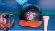 Apr 21, 2024; Kansas City, Missouri, USA; Baltimore Orioles hat and glove sits in the dugout during the ninth inning against the Kansas City Royals at Kauffman Stadium. Mandatory Credit: William Purnell-Imagn Images