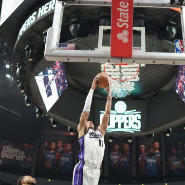 Dec 6, 2023; Los Angeles, California, USA; Sacramento Kings forward Kessler Edwards (17) dunks the ball against the LA Clippers in the second half at Crypto.com Arena. Mandatory Credit: Kirby Lee-USA TODAY Sports