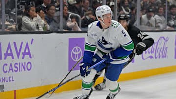 Nov 29, 2025; Los Angeles, California, USA; Vancouver Canucks defenseman Tom Willander (5) is chased down by Los Angeles Kings center Phillip Danault (24) along the boards during the second period at Crypto.com Arena. Mandatory Credit: Jayne Kamin-Oncea-Imagn Images