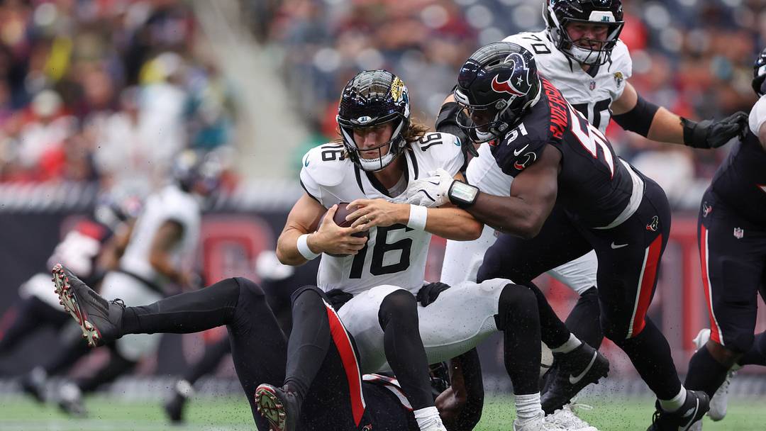 Nov 9, 2025; Houston, Texas, USA; Houston Texans defensive end Danielle Hunter (55) and defensive end Will Anderson Jr. (51) attempt to sack Jacksonville Jaguars quarterback Trevor Lawrence (16) during the game at NRG Stadium. Mandatory Credit: Troy Taormina-Imagn Images