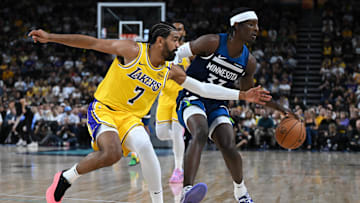 Oct 4, 2024; Palm Desert, California, USA; Los Angeles Lakers guard Gabe Vincent (7) passes against Minnesota Timberwolves forward Leonard Miller (33) during the second half at Acrisure Arena. Mandatory Credit: Jonathan Hui-Imagn Images