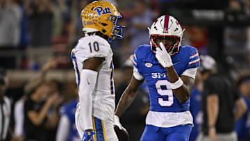 Nov 2, 2024; Dallas, Texas, USA; Southern Methodist Mustangs wide receiver Key'Shawn Smith (9) celebrates after he makes against Pittsburgh Panthers defensive back Ryland Gandy (10) during the second half at Gerald J. Ford Stadium. Mandatory Credit: Jerome Miron-Imagn Images