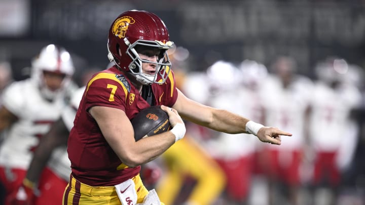 Dec 27, 2023; San Diego, CA, USA; USC Trojans quarterback Miller Moss (7) points while running the ball during the first half against the Louisville Cardinals at Petco Park. 